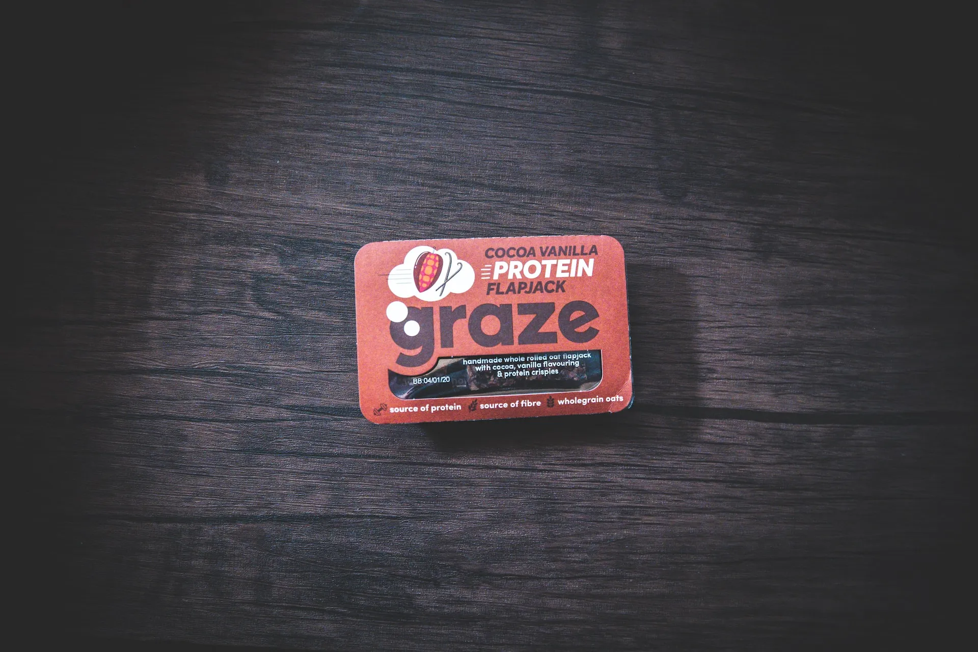 Graze Flapjack protein energy bar on black surface